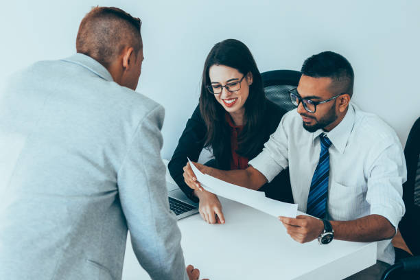 istock Cheerful financiers examining business documents 923590096