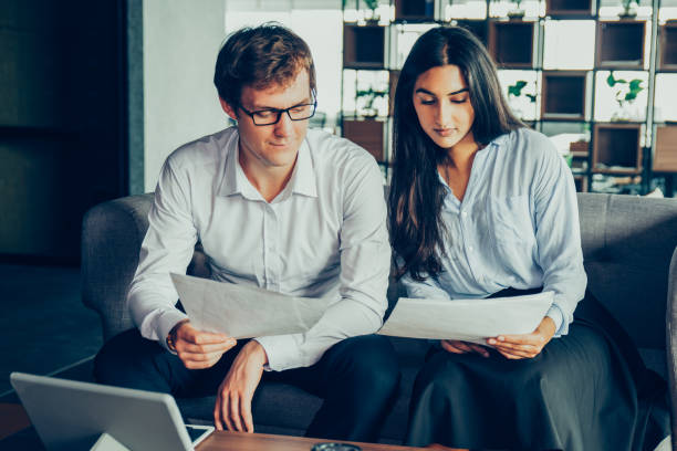 istock Concentrated business people discussing report 923594252