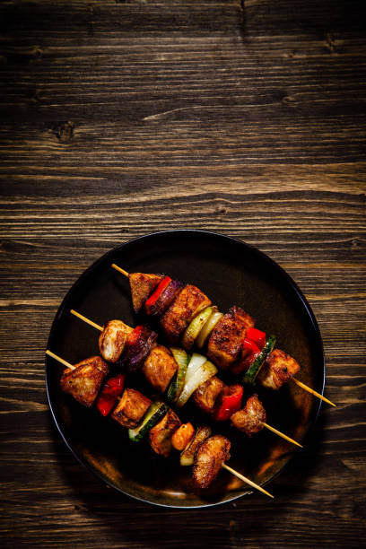 istock Kebabs - grilled meat and vegetables on white background 923594298