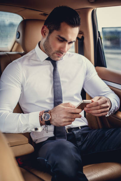 istock Stylish male in a white shirt using smartphone. 923596924