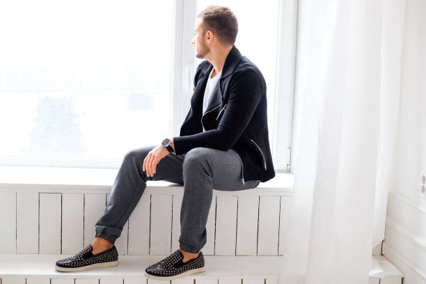 istock Casual guy posing on white wooden steps. 923598578