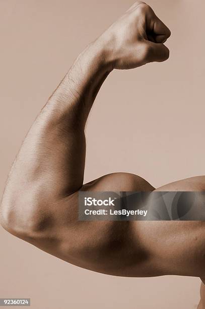 Closeup On Man Flexing His Bicep Muscle Stock Photo - Download Image Now - Adult, Aspirations, Beautiful People