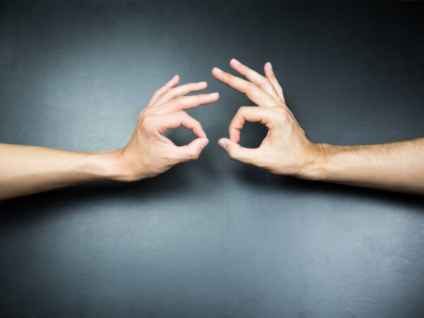 istock two OK hands gestures to each other on black background 923605674