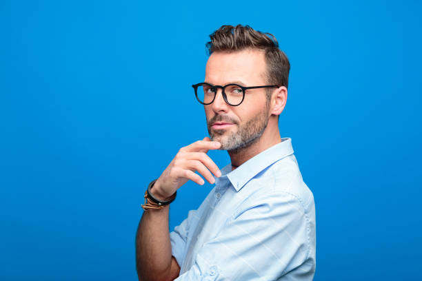 istock Portrait of confident, handsome man, blue background 923611030