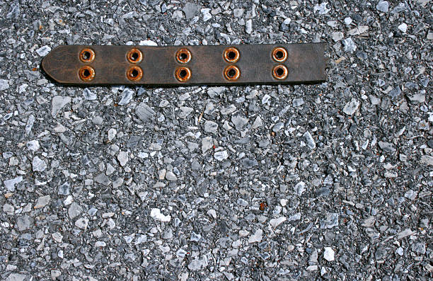 Leather Belt Piece on Asphalt stock photo