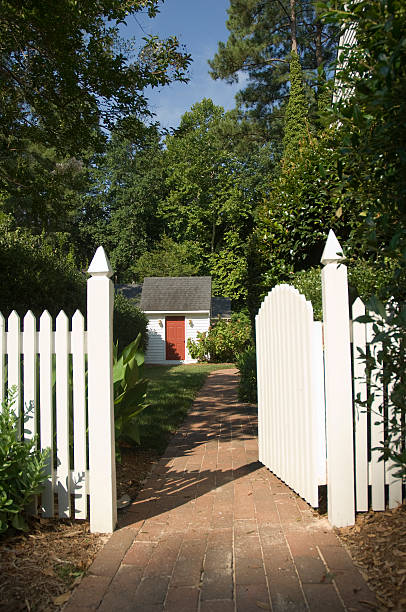 Orange brick stone fence and wooden white gate. natural materials