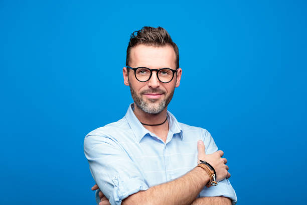istock Summer portrait of cheerful, handsome man, blue background 923613458