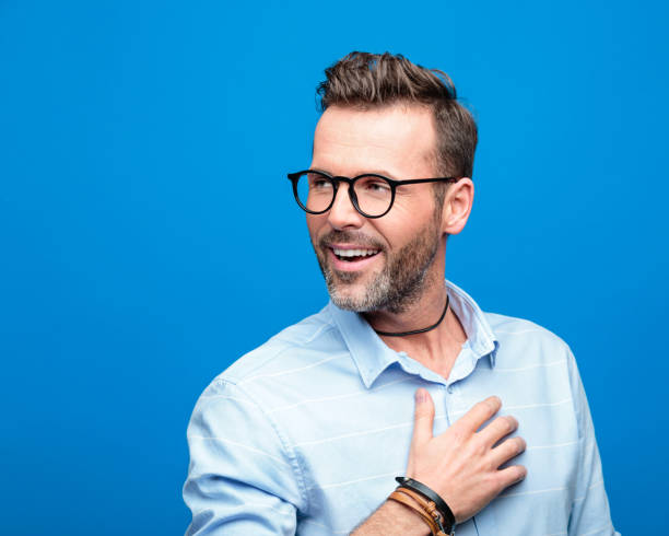 istock Summer portrait of happy man, blue background 923613848
