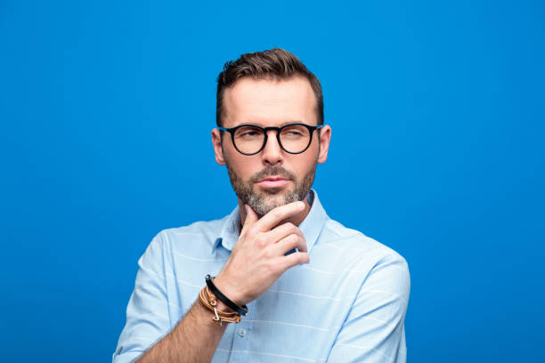 istock Summer portrait of confident, handsome man, blue background 923614500
