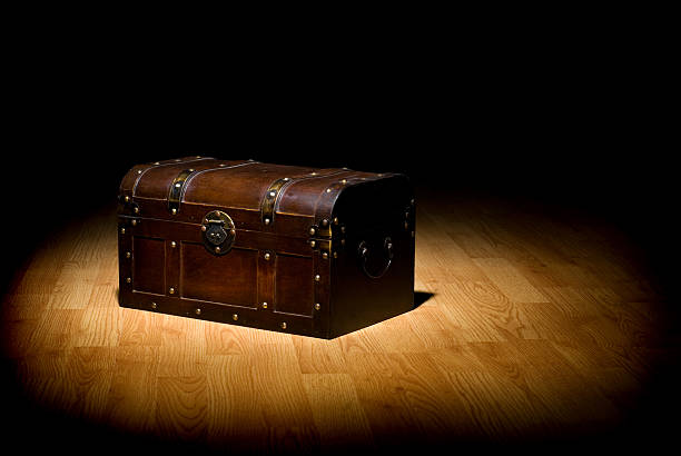 An unopened treasure chest in the spot light stock photo