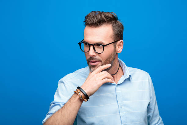 istock Portrait of charming, handsome man, blue background 923617550