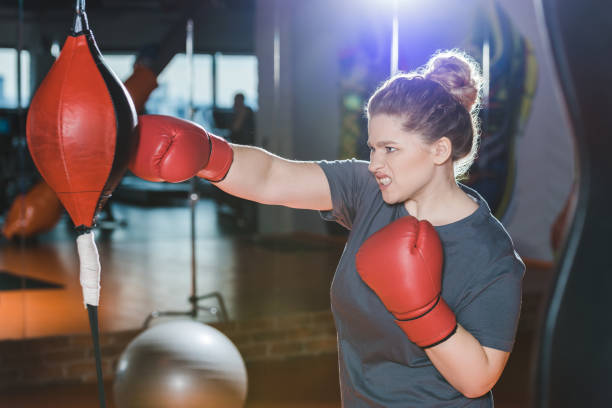 istock overweight woman having boxing training at gym 923618152