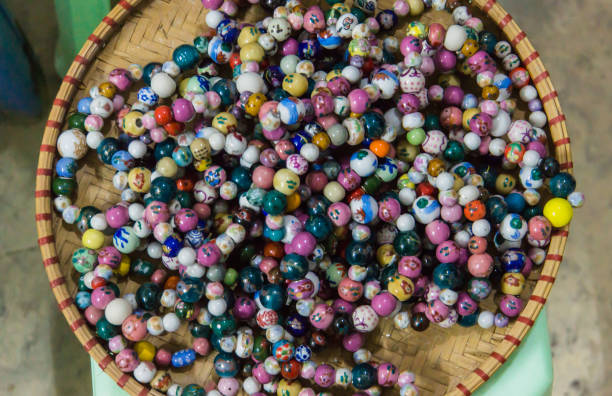 ceramic beads basket of ceramic beads in many colors and designs strung in bracelets bat trang stock pictures, royalty-free photos & images