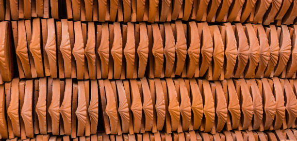 red ceramic roof tiles rows of red ceramic roof tiles lined up ready to put on new roof bat trang stock pictures, royalty-free photos & images