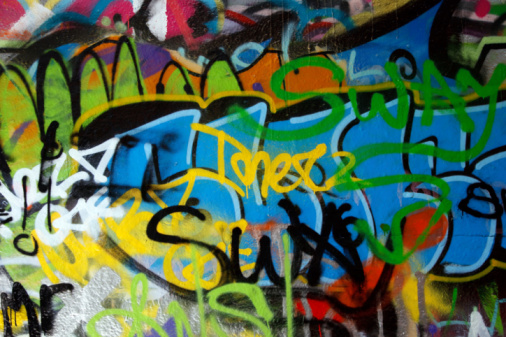 Glasgow, Scotland - Close-up of a collection of spray paint cans on the street.