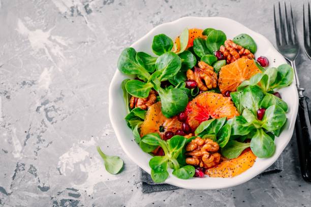 istock Green Lamb’s lettuce corn salad with blood oranges, walnuts, pomegranate and chia seeds 923620816