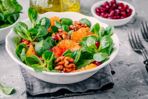 istock Green Lamb’s lettuce corn salad with blood oranges, walnuts, pomegranate and chia seeds 923621944