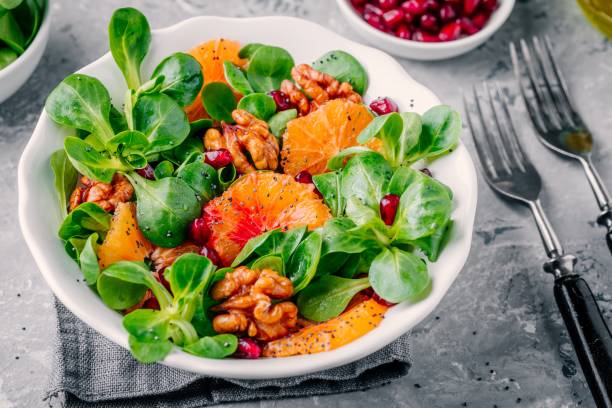 istock Green Lamb’s lettuce corn salad with blood oranges, walnuts, pomegranate and chia seeds 923622014