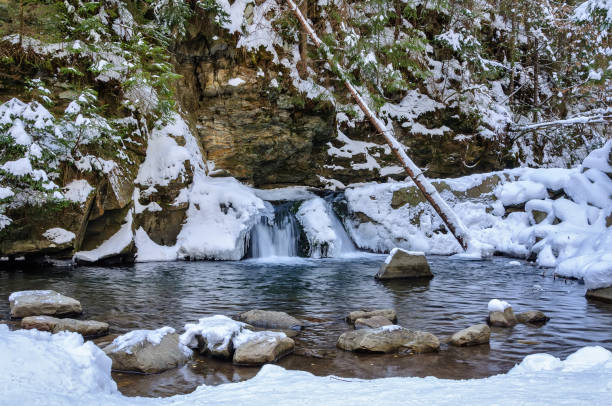istock Waterfall in winter. Mountain river and snow on the mountain slopes 923624856