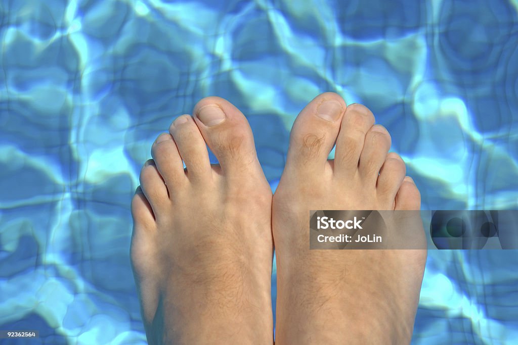 Feet in water on swimming pool  Color Image Stock Photo
