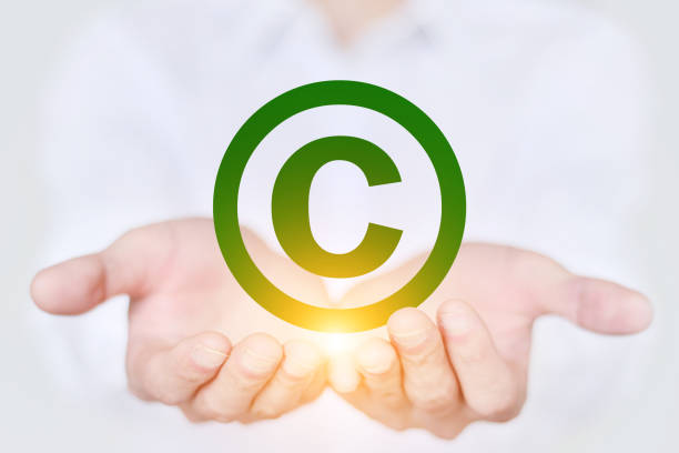 istock Business men hold copyrighted icons 923625946