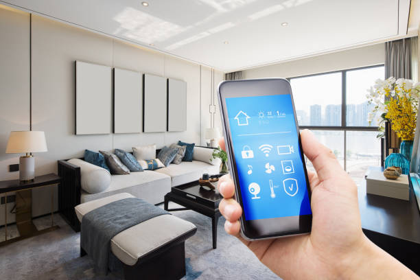 smart home system on mobile phone with background smart home system on mobile phone with background of modern living room home automation stock pictures, royalty-free photos & images