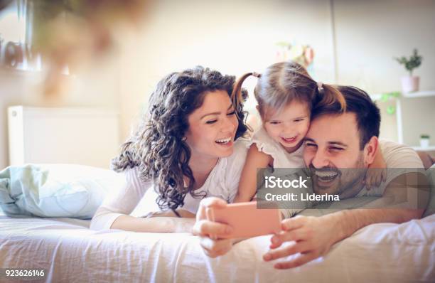 Let Take A Photo Of Our Happy Family Stock Photo - Download Image Now - Family, Happiness, Young Family