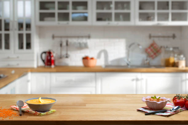 wooden table on blurred kitchen interior background - vegetables table imagens e fotografias de stock