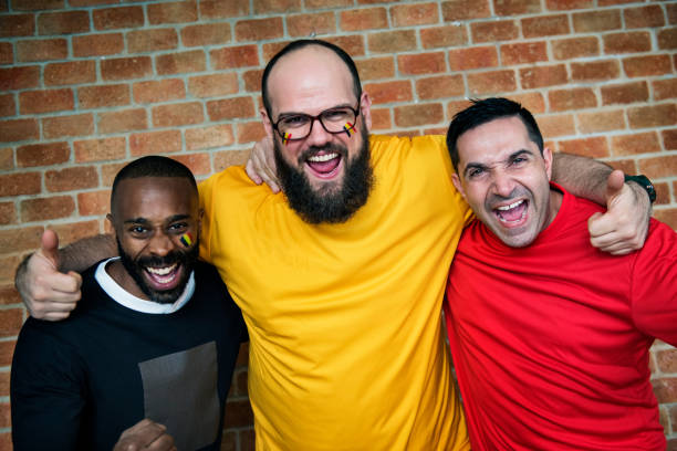 Friends cheering world cup with painted flag