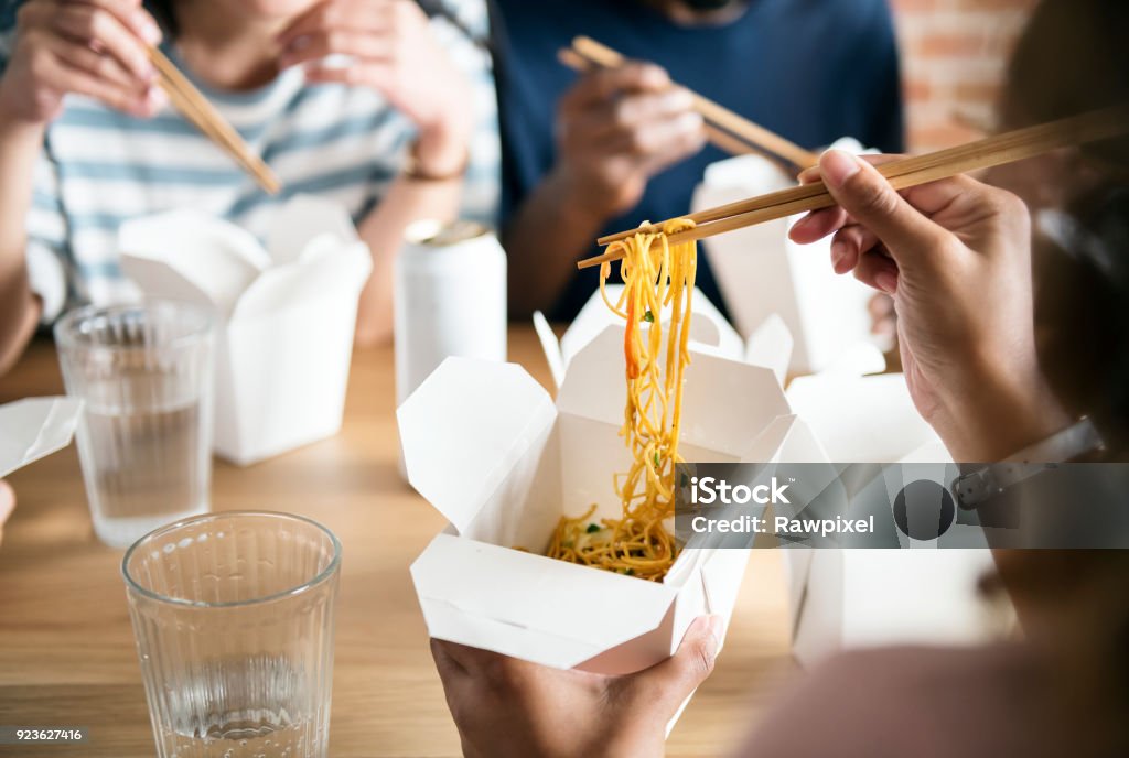 Friends eating Chow mein together Take Out Food Stock Photo