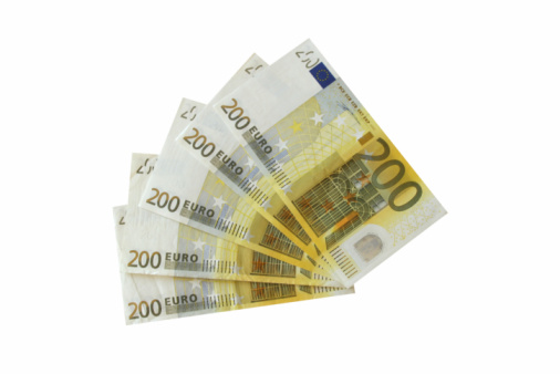 Close-up image of the Euro symbol at the centre of a collection of modern Euro notes.