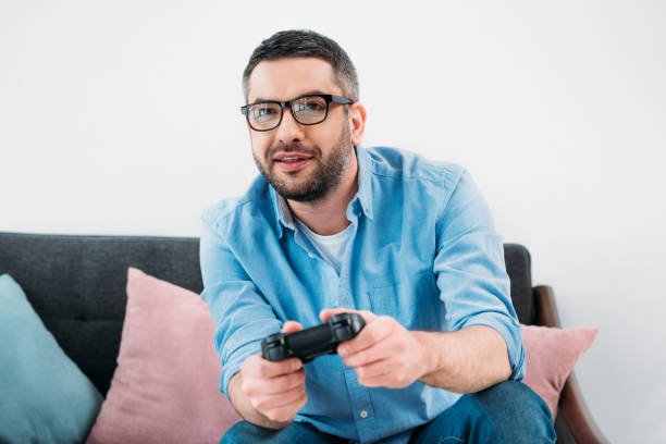 istock portrait of focused man playing video game at home 923630794