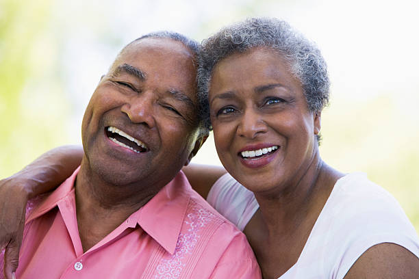 Happy african couple having tender moment outdoors at summer sunset