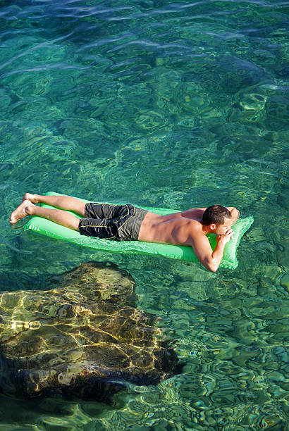 Relaxing on a Lilo stock photo