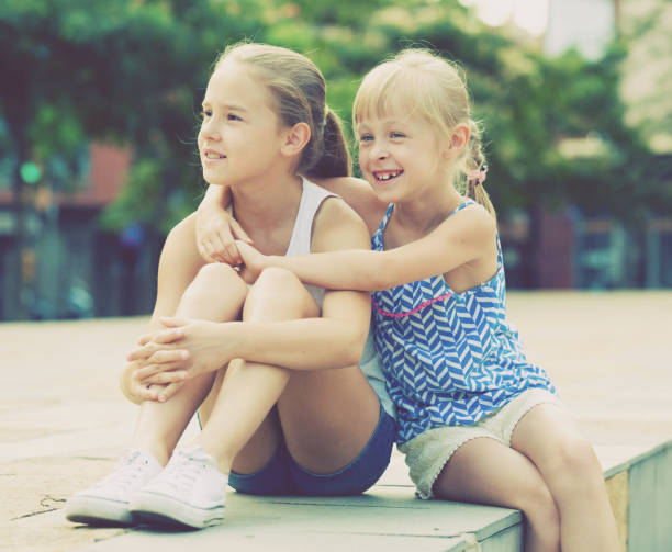 istock Two small happy sisters outdoors 923638564