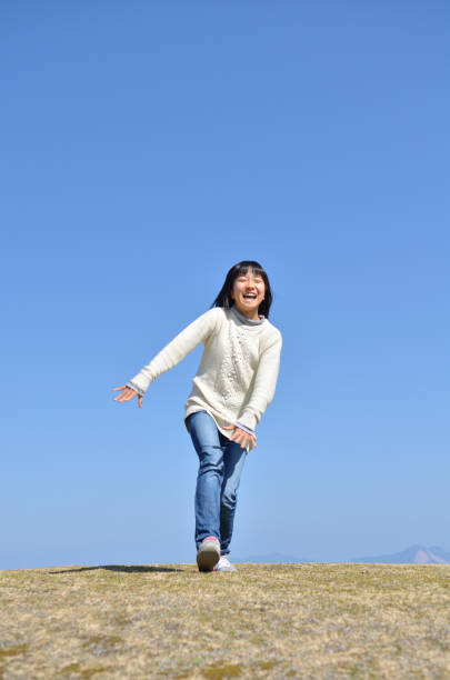 istock Girl's running in the blue sky 923639126