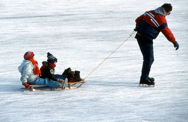 istock Dad Towing Kids on Ice Rink 92363974