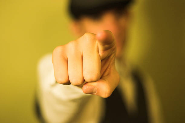 Detail of man pointing index finger on yellow background  stock photo
