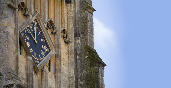 Close up of the Clock face of the historic Church of St John the Baptist in Cirencester, Gloucestershire in The Cotswolds