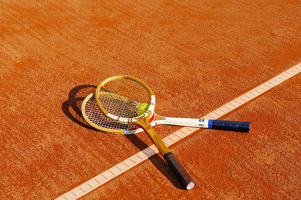 istock old tennis racket on the sand court 92364482