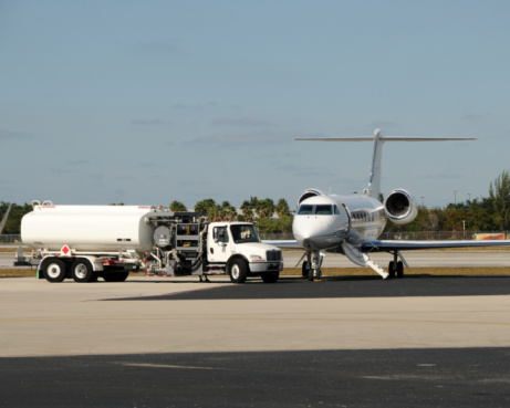 Modern business jet refueled on a tarmac