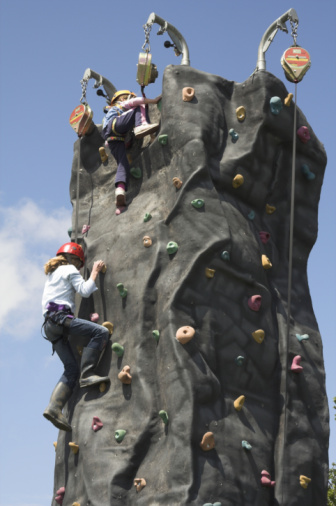 two climbers reacing the top