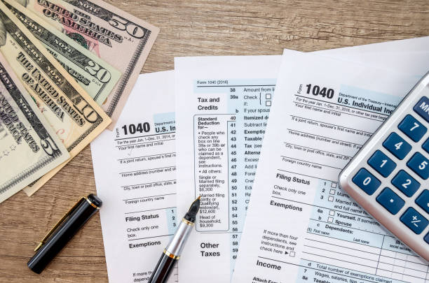 istock 1040 Tax form, dollar and calculator 923651970