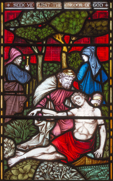 london - the parable of the good samaritan  on the stained glass in st mary abbot's church on kensington high street. - stained glass jesus christ glass church imagens e fotografias de stock