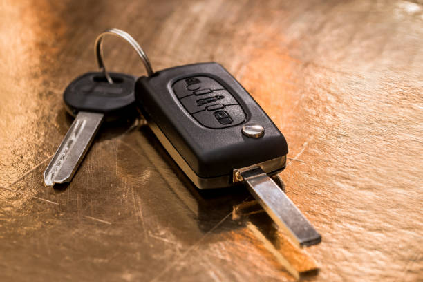 istock car key isolated on gold. close up 923652148