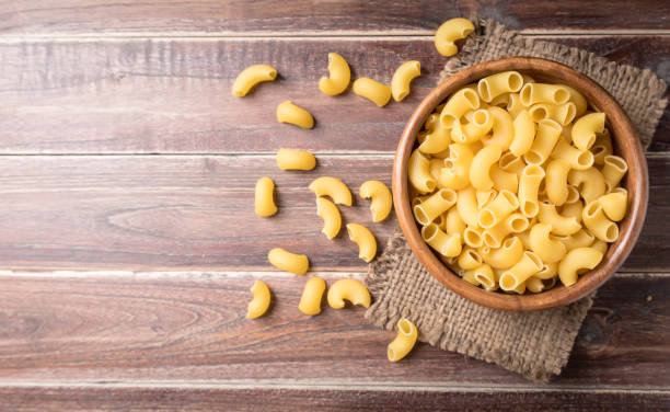 istock Raw macaroni on wooden background,Top view 923652178