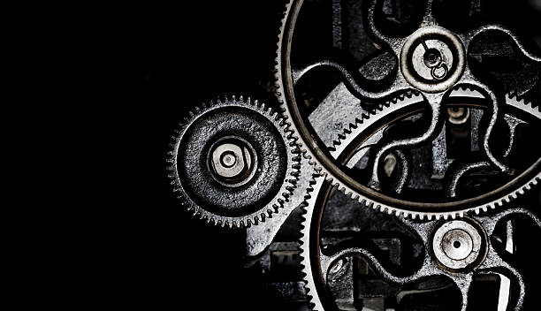 Different sized gears interlocked machinery background of engaged gears with copy space bicycle gear stock pictures, royalty-free photos & images