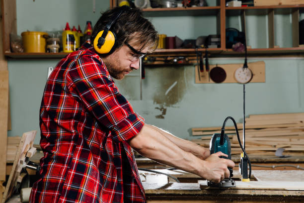 istock Carpenter working of manual hand milling machine in the carpentry workshop. joiner 923655976