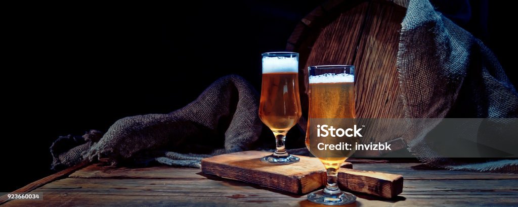 Beer next to the barrel Beer glasses on the bar counter next to the old oak barrel Beer - Alcohol Stock Photo