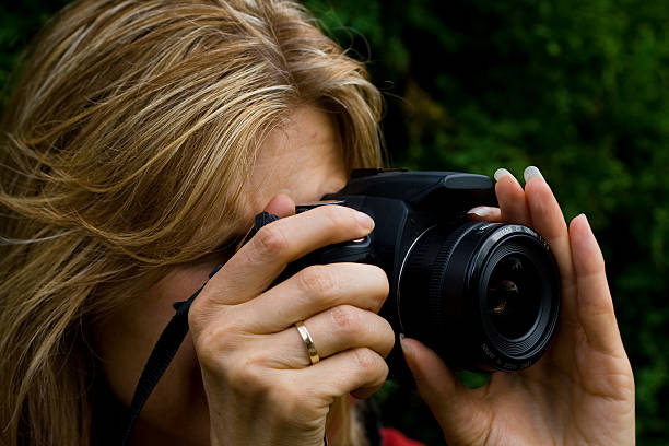 istock Woman Holding an SLR Camera 92366308
